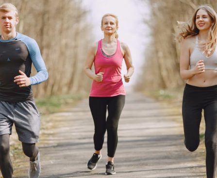 Three adults jogging on a park path, embracing a healthy and active lifestyle.